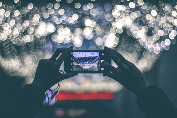 woman-photographing-lights-at-night