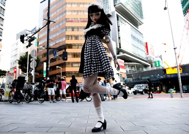 "Doll" model Lulu Hashimoto poses to a photographer on the street during an interview with Reuters in Tokyo